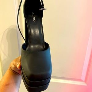 Also black satin platform pump